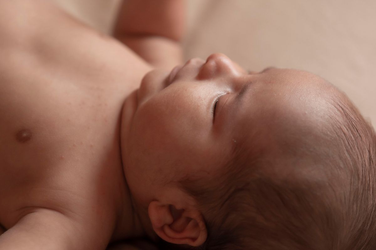 Close-up of a sleeping newborn baby's head and scalp
