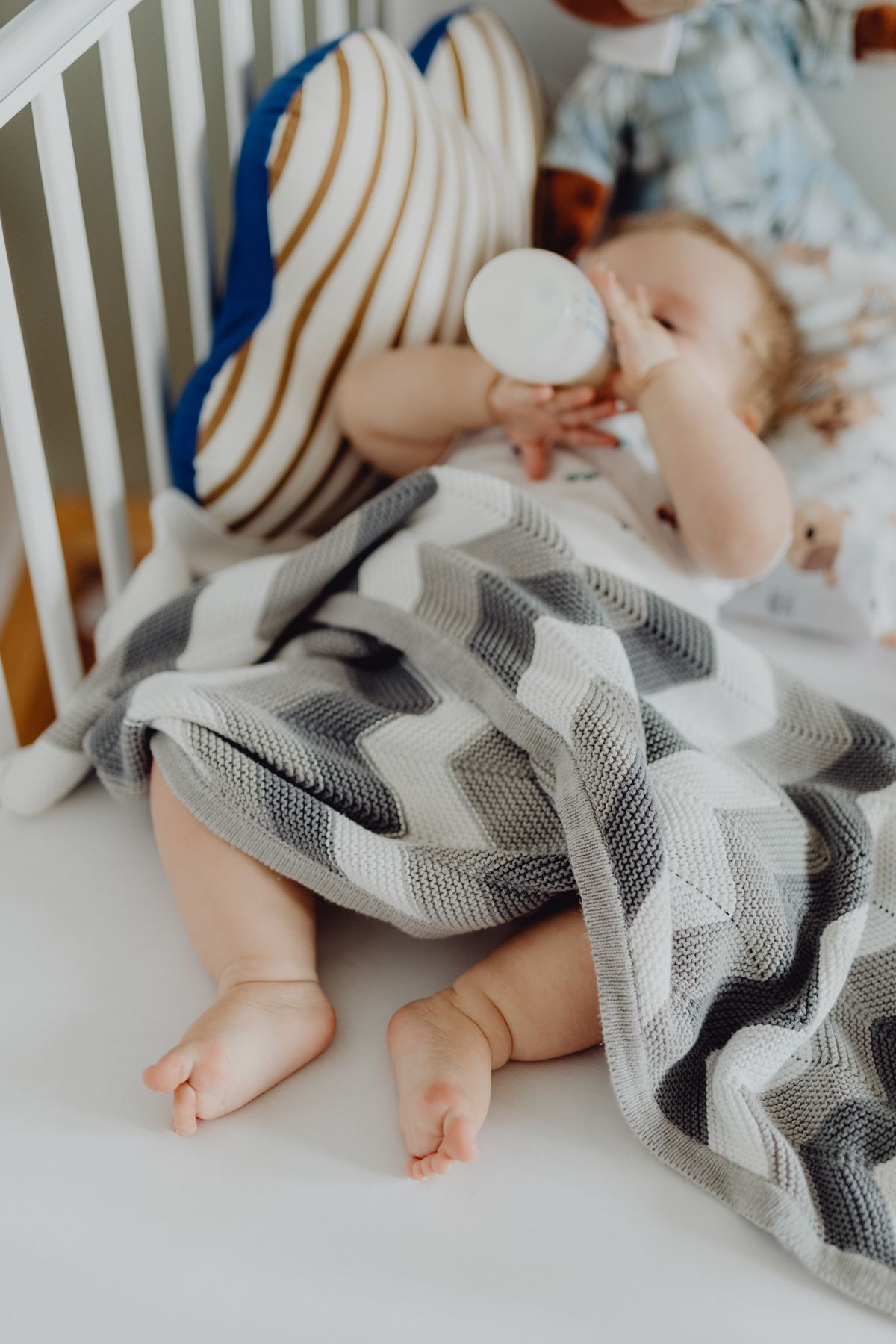 A baby sleeping peacefully on their back in a crib