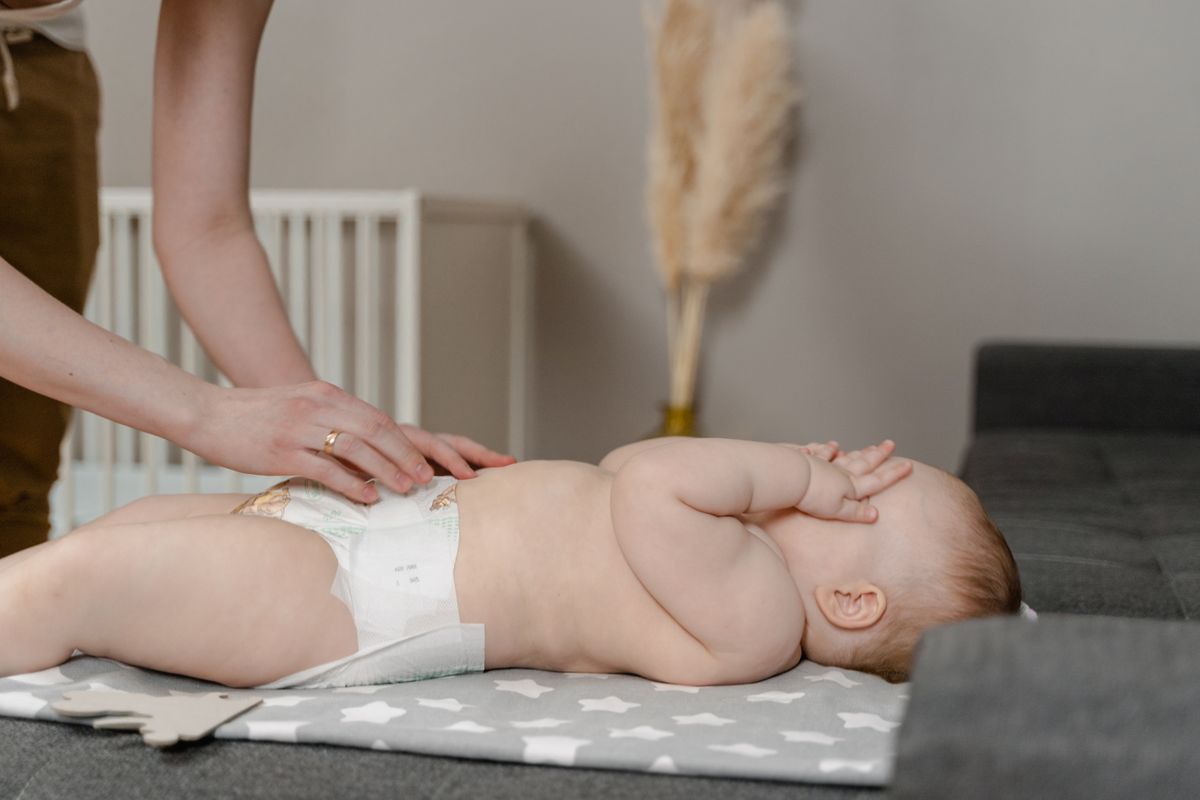 A parent cleaning a baby during a diaper change