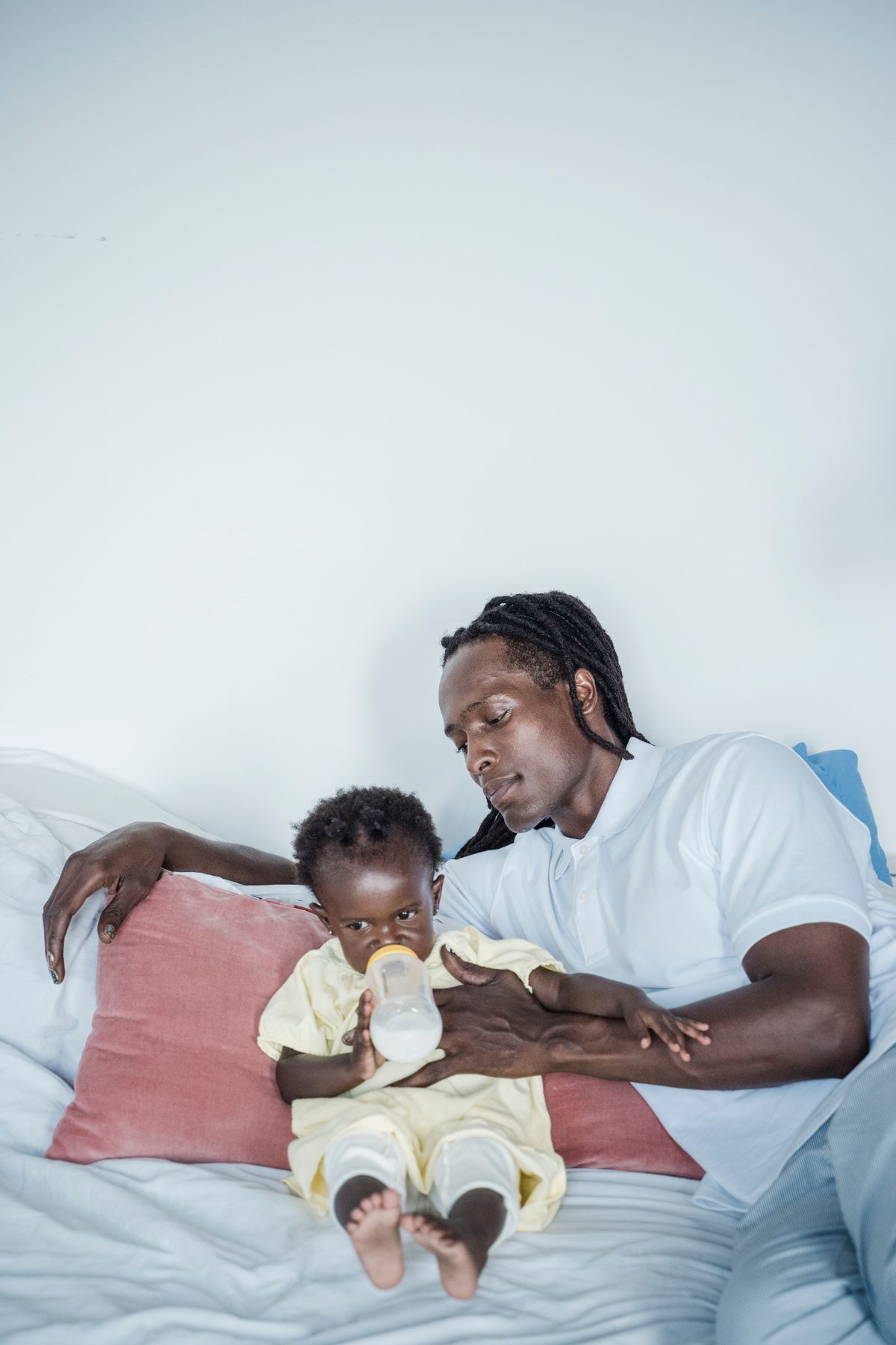 A father feeding a baby with a bottle