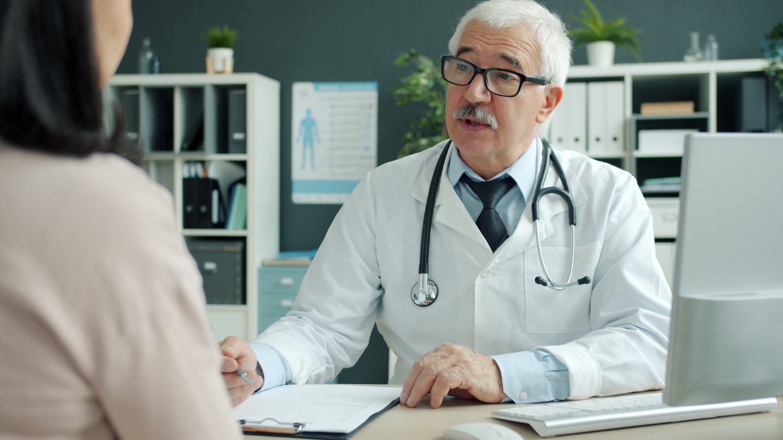Doctor talking with a patient in a consultation office