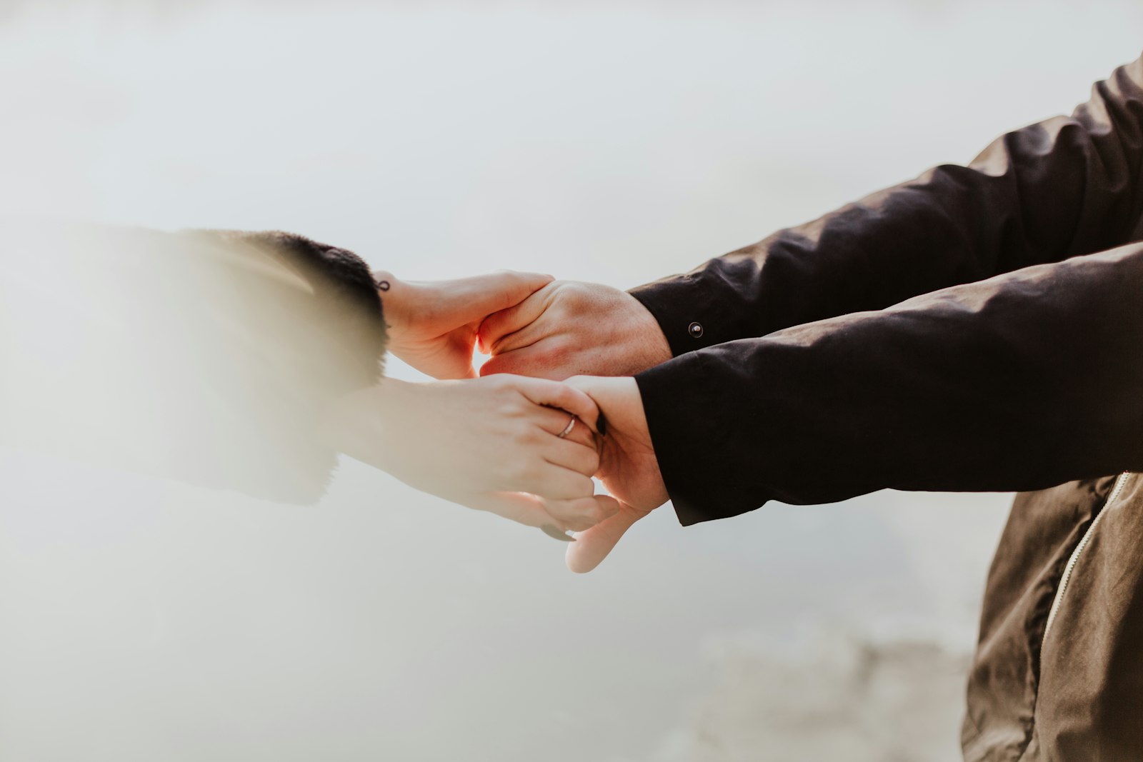 A couple holding hands while standing together