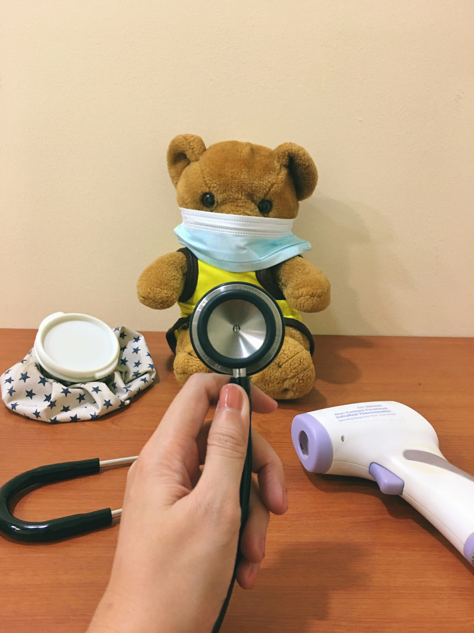 Pretend-play doctor kit with a stethoscope and toy bear