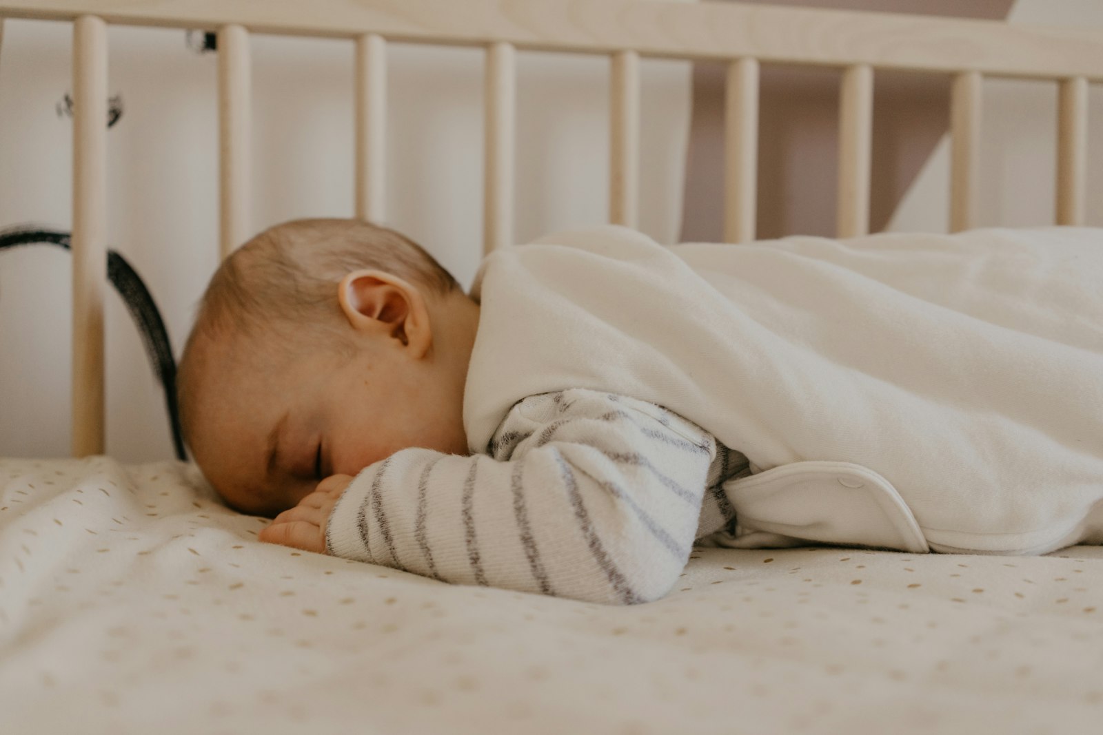 Baby sleeping peacefully in a crib