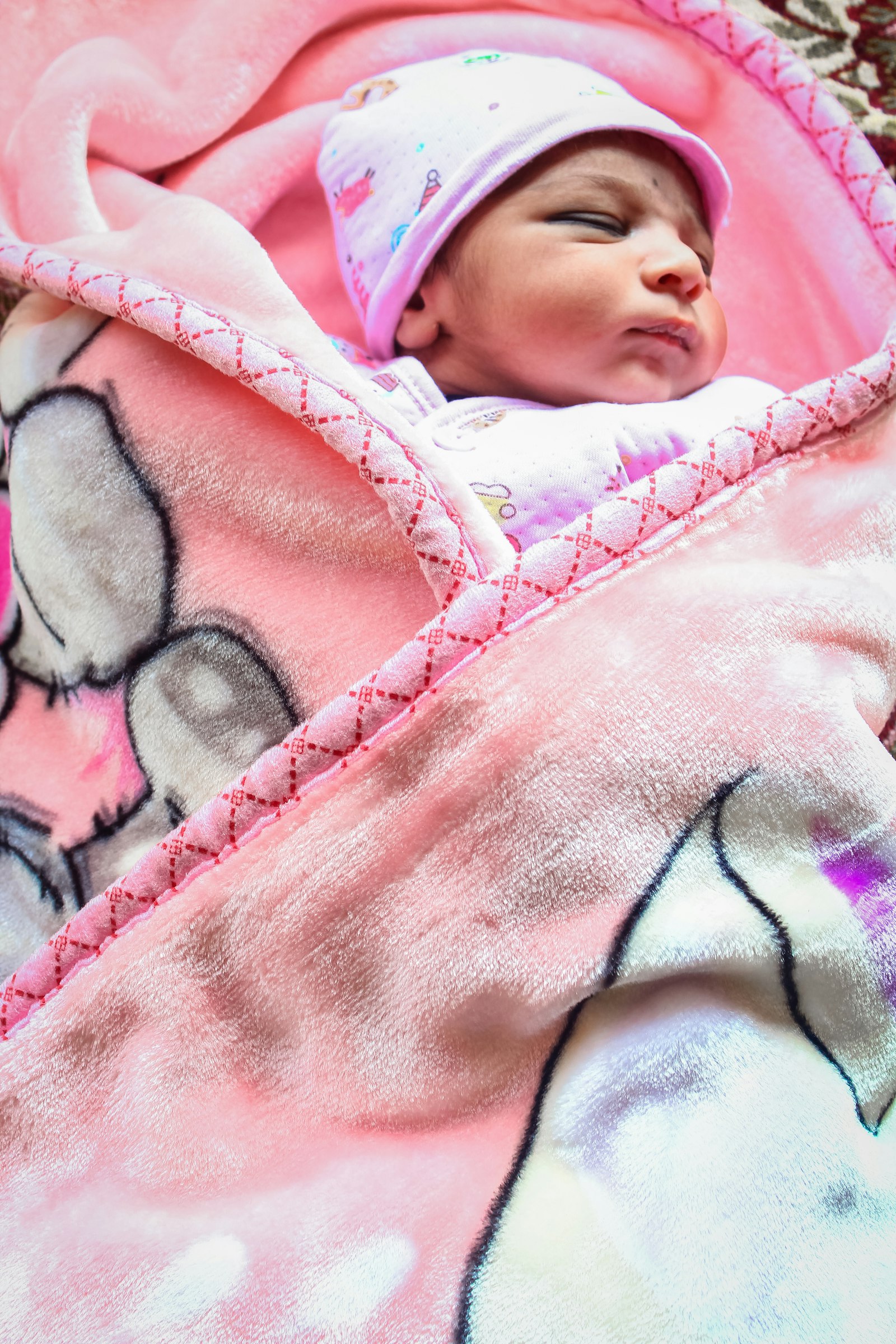 A swaddled newborn sleeping peacefully